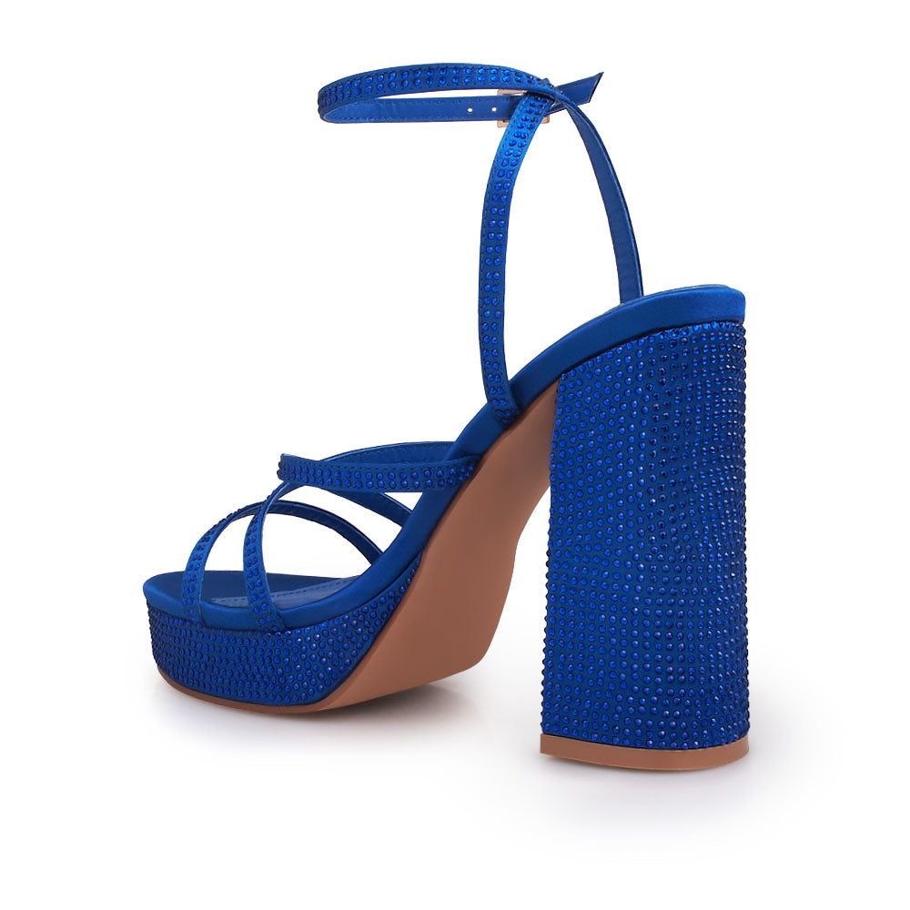 Cobalt colored platform heels with crystal embellishment and ankle buckle closure - back view
