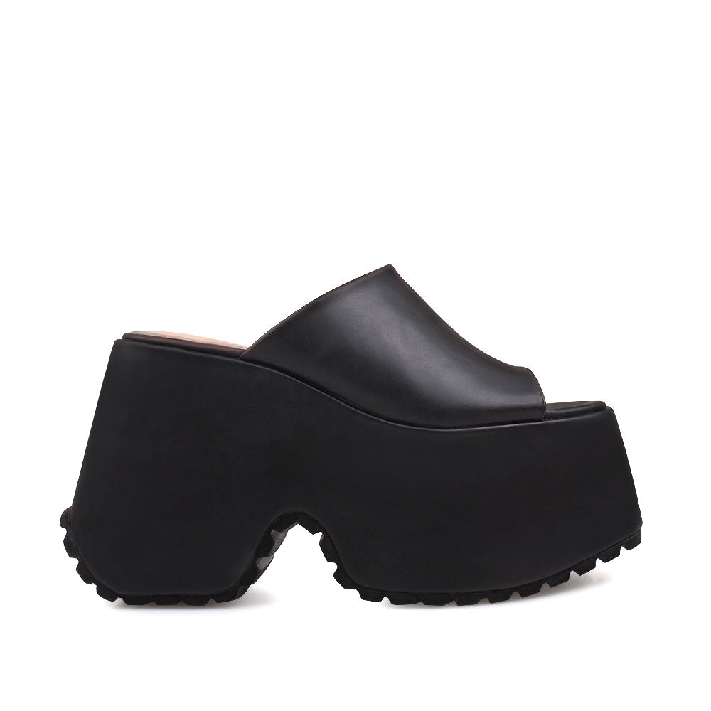 Black platforms with an open toe and slip-on style - side view
