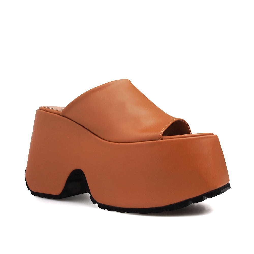 Slip-on tan colored platforms with an open toe - corner view