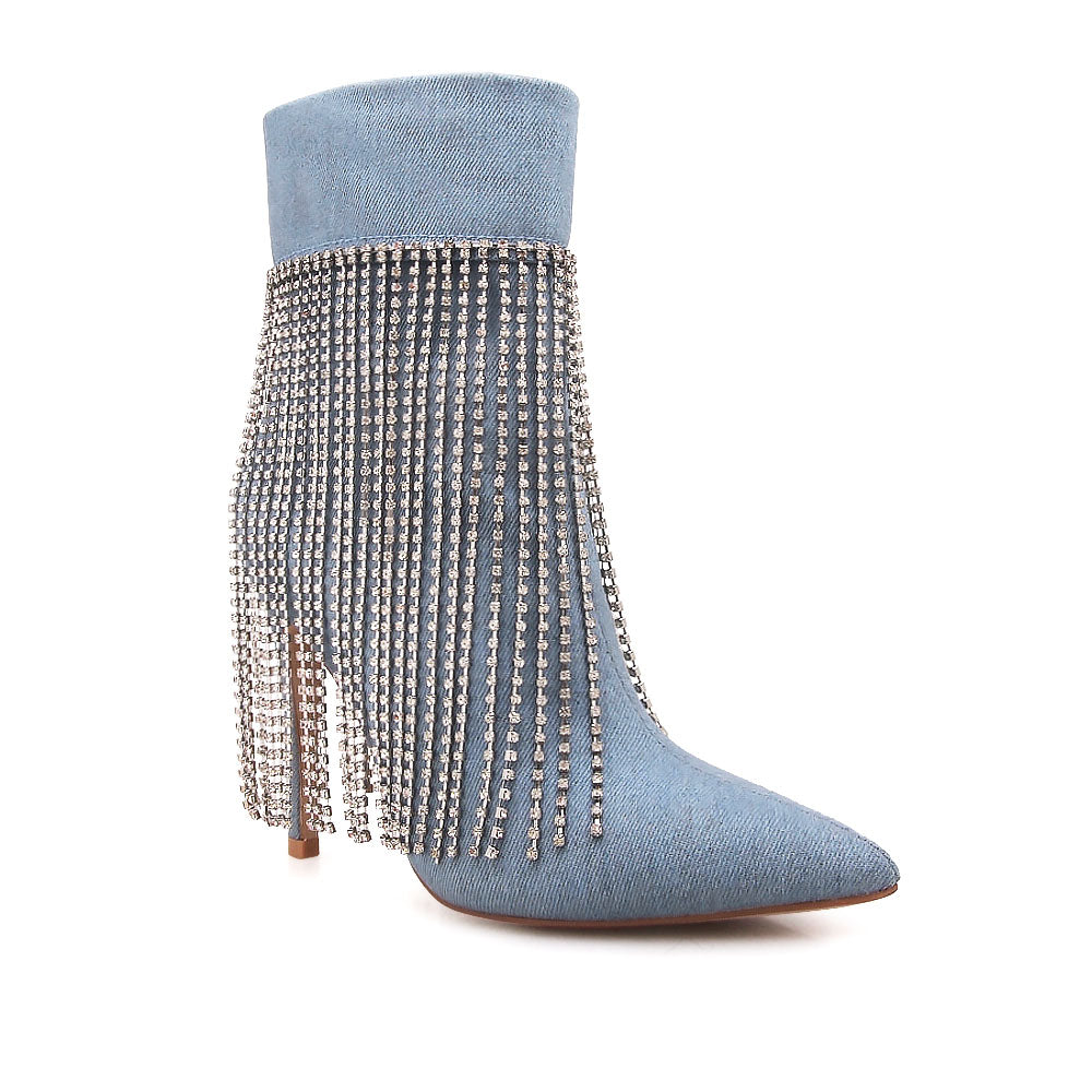 Denim colored pointy toe ankle boots with stiletto heels and rhinestone fringe design - corner view