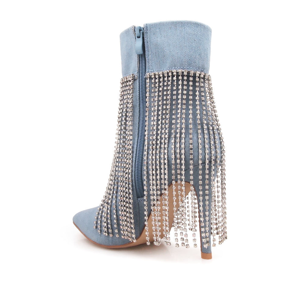 Denim colored pointy toe ankle boots with stiletto heels and rhinestone fringe design - back view