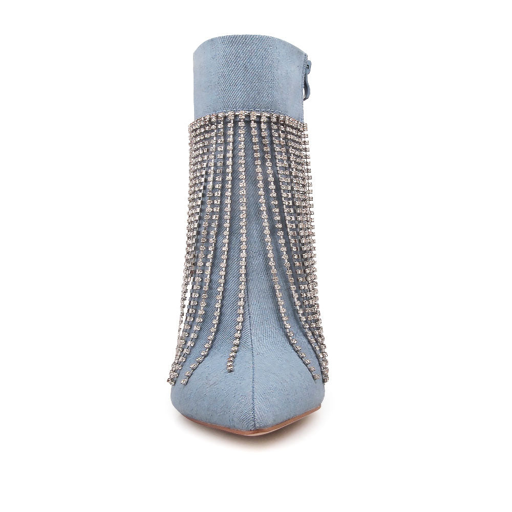 Denim colored pointy toe ankle boots with stiletto heels and rhinestone fringe design - front view