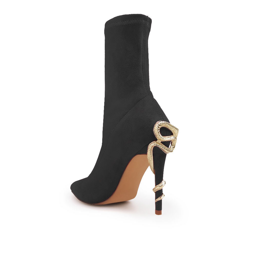 Black pointed toe stiletto heels boots with snake design on heels - back view