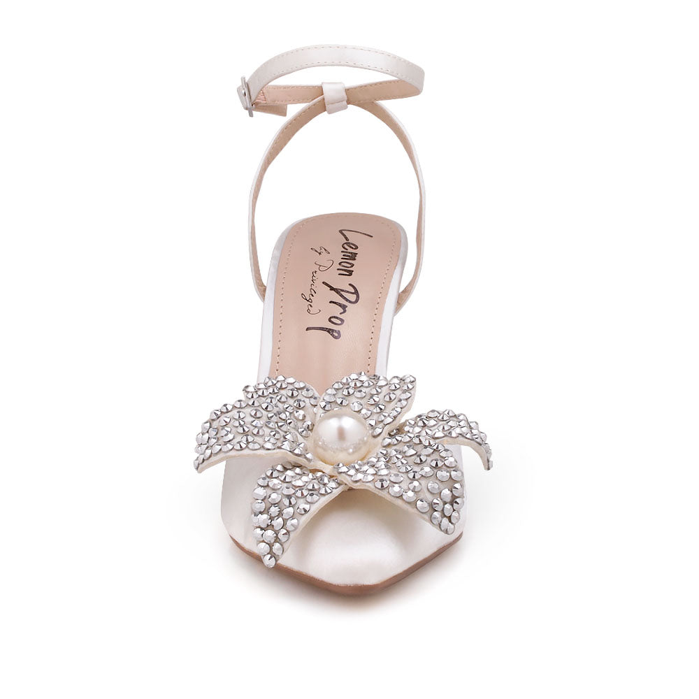 White stiletto heel with flower pearl embellished upper and ankle strap closure - front view