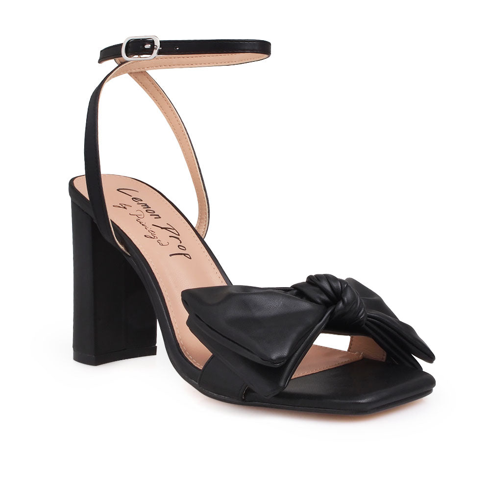 Black heels with bow design upper and ankle buckle clasp - corner view