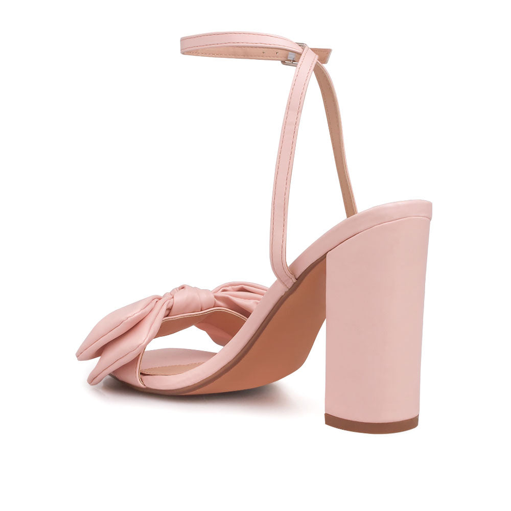 Blush heels with bow design upper and ankle buckle clasp - back view