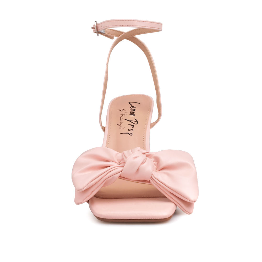 Blush heels with bow design upper and ankle buckle clasp - front view