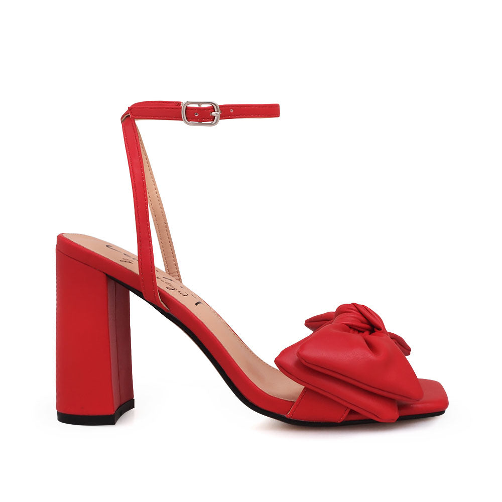 Red heels with bow design upper and ankle buckle clasp - side view