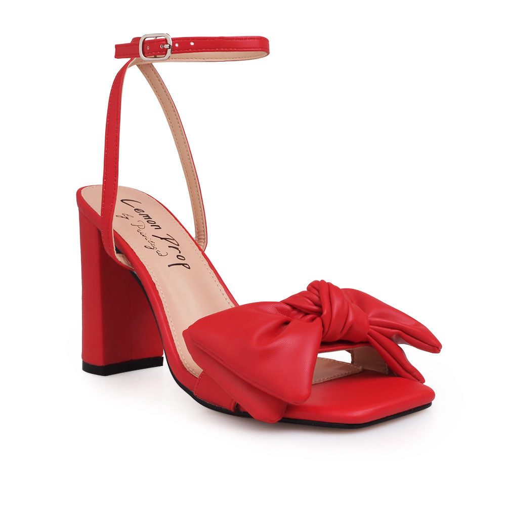 Red heels with bow design upper and ankle buckle clasp - corner view