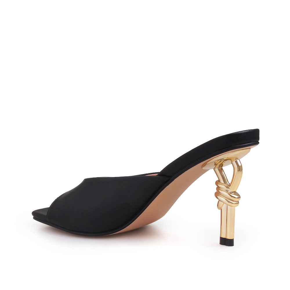 Golden knot metal heels with black colored upper and squared toe sandals - back view
