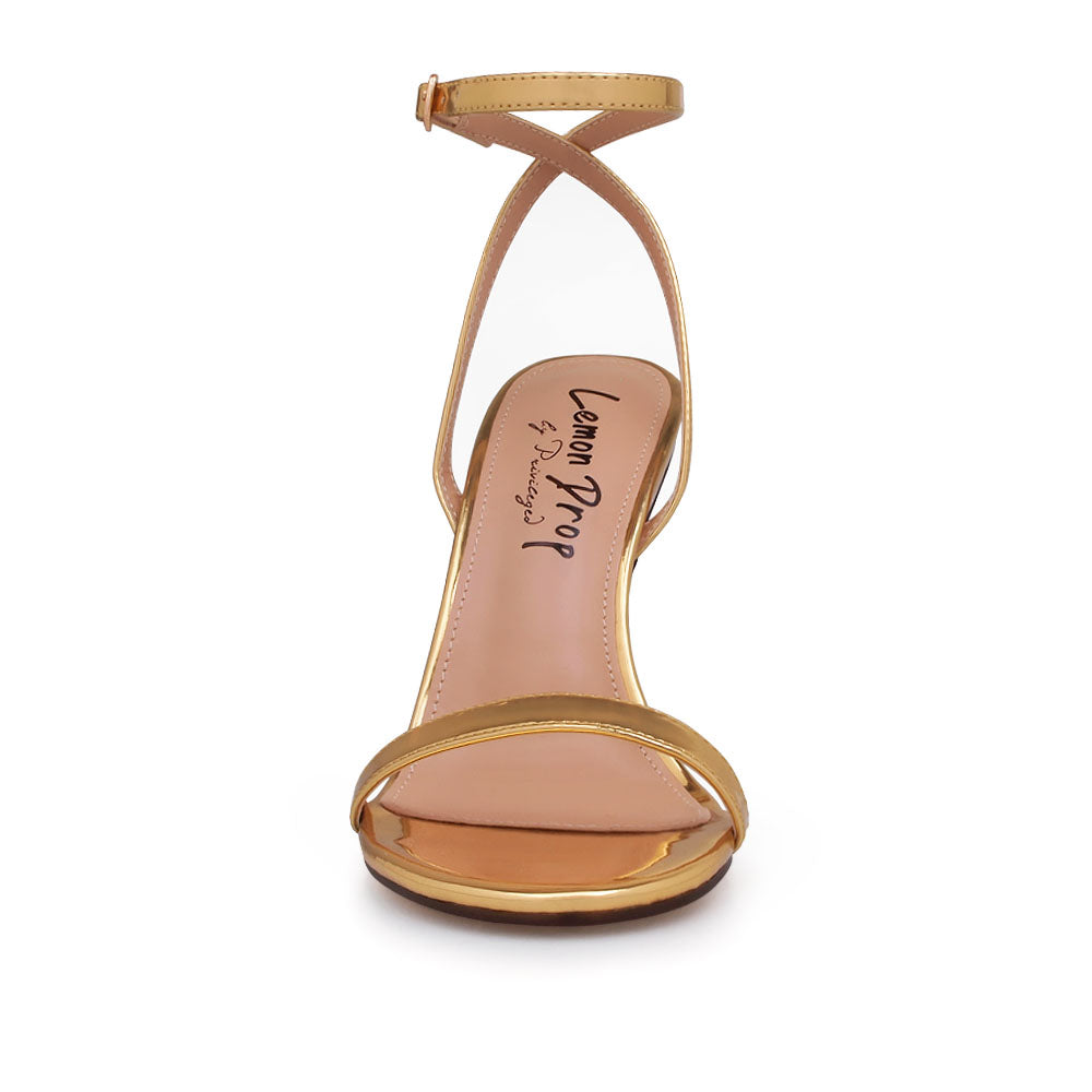 Golden metallic heels with ankle buckle closure and open toe design - front view