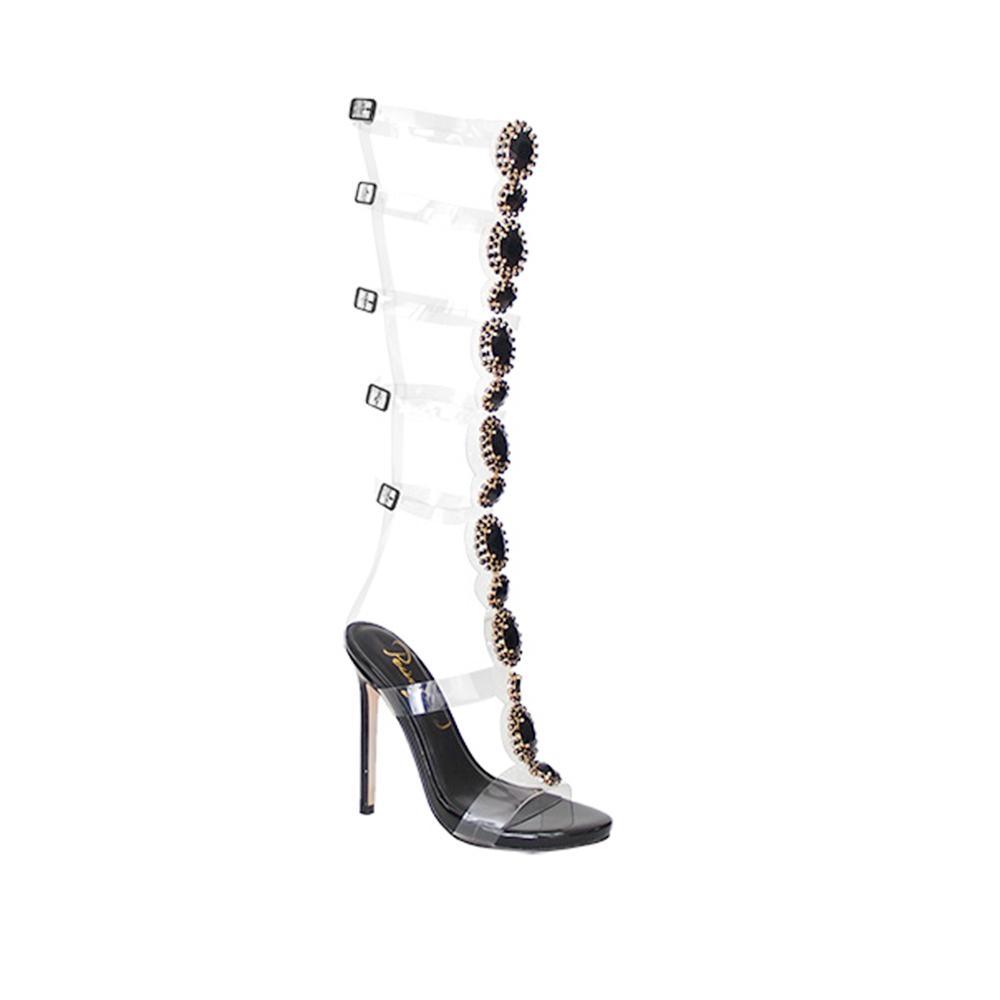 Heels in black tone with knee-high jewel decoration and belt strap fastening