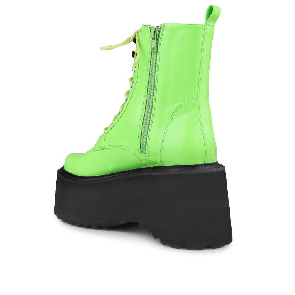 Green colored women platform boots with black base-posterior view