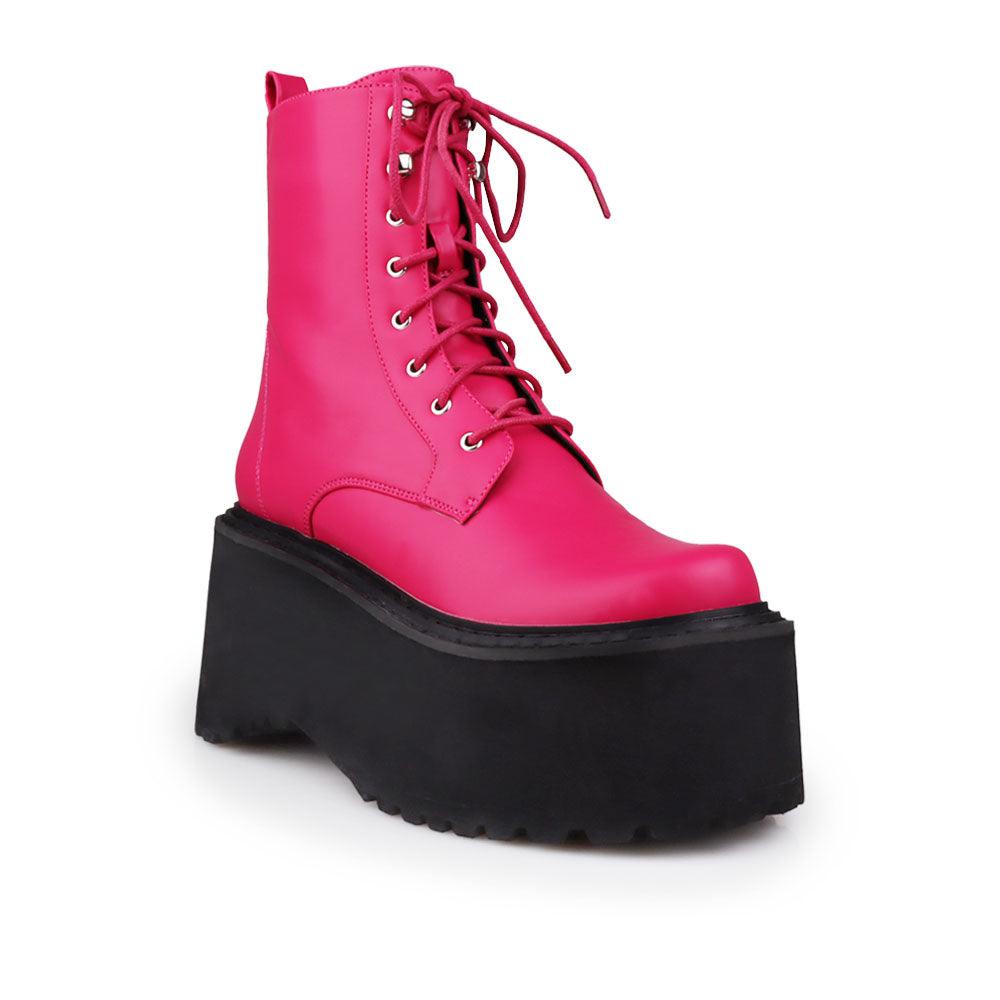 Pink colored women platform boots with black base-corner view