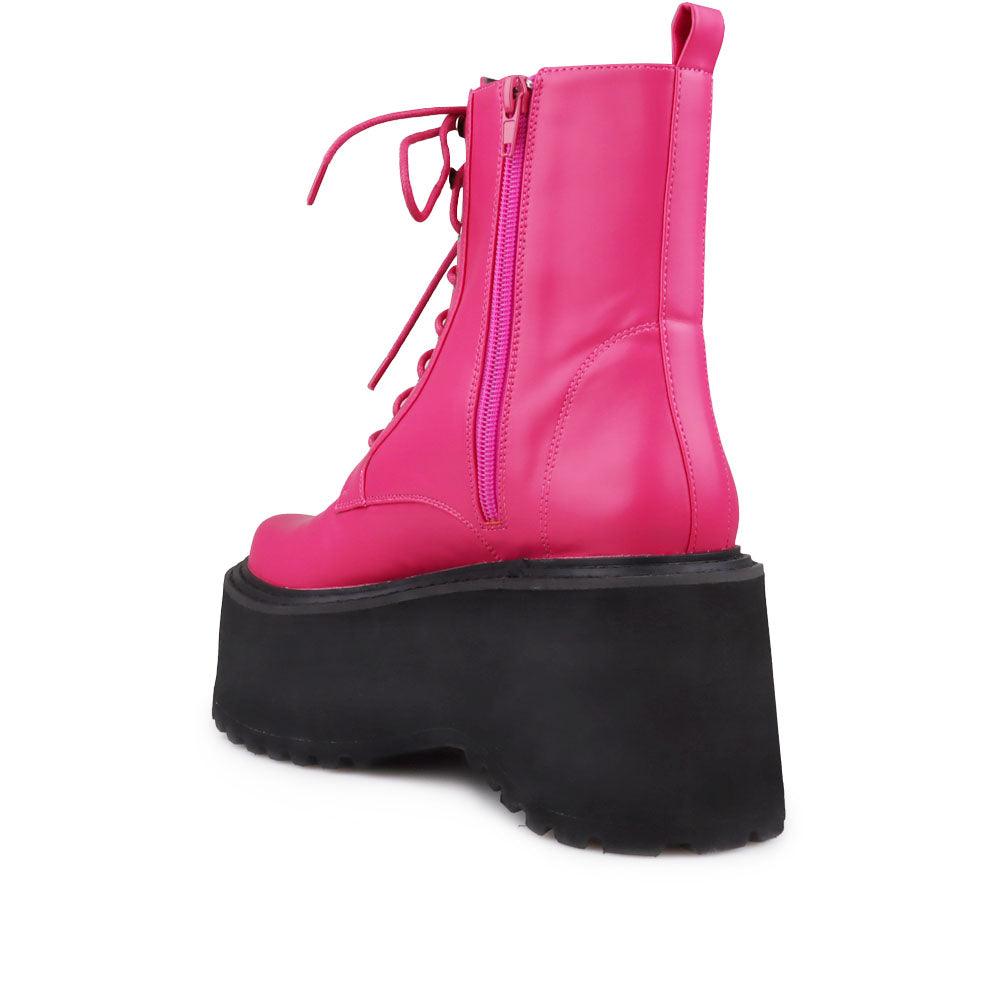 Pink colored women platform boots with black base-posterior view