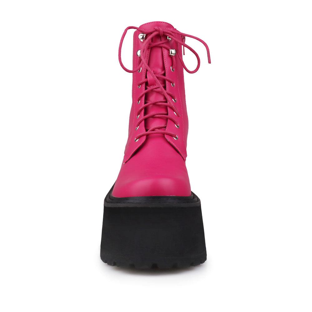 Pink colored women platform boots with black base-front view
