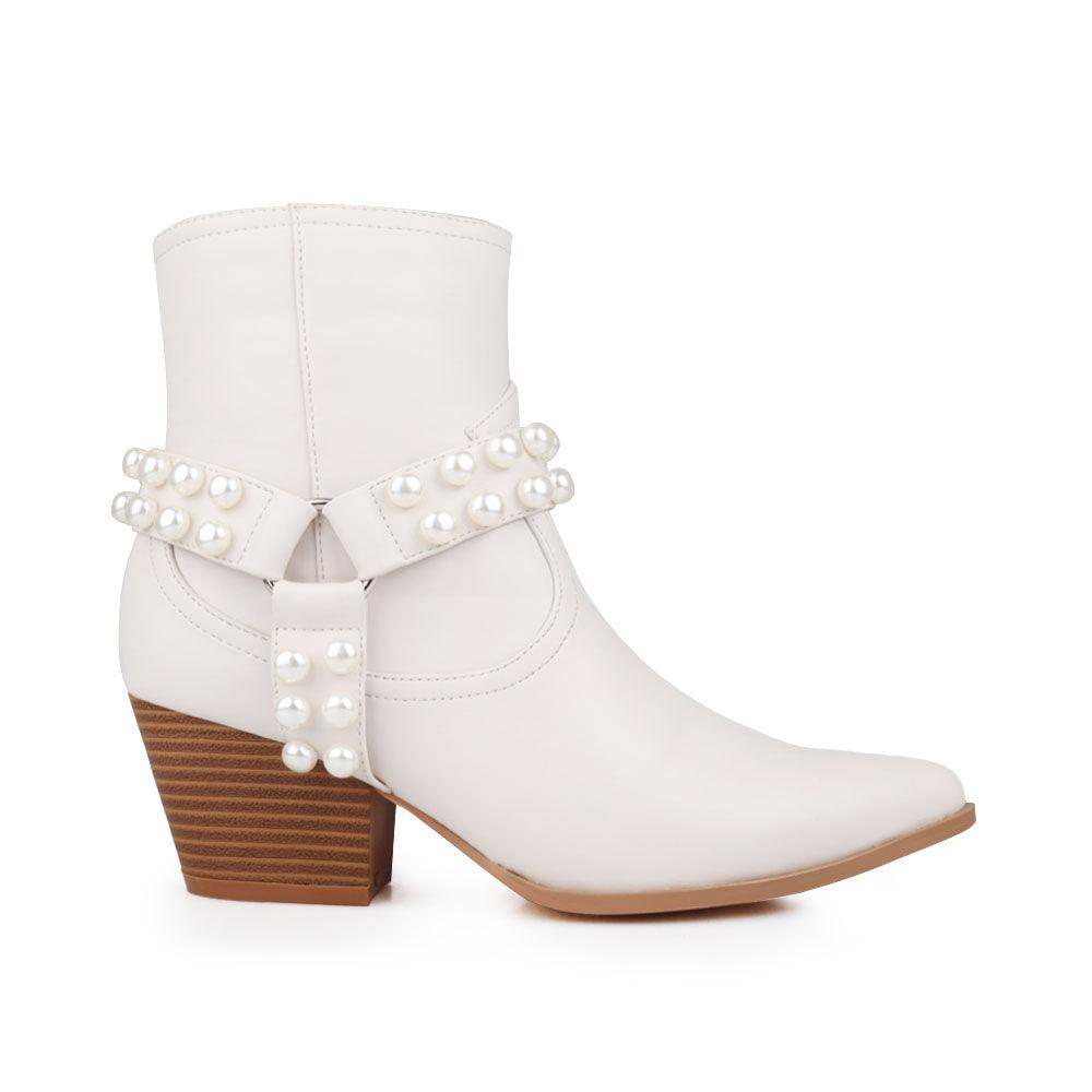 Bone white colored shoes with beaded ankle and pointed toe.