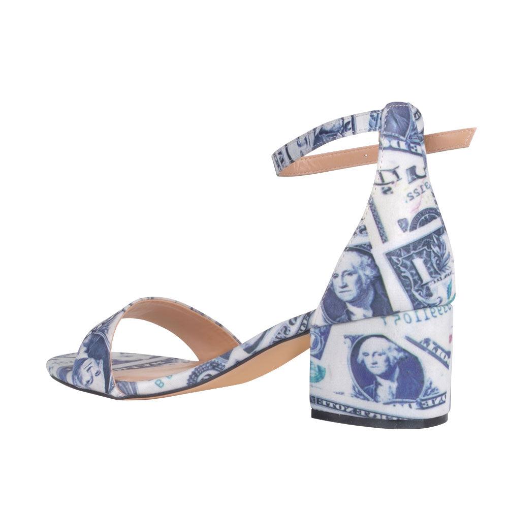 Heel flats with a black and white pattern with strap and ankle buckle closure-posterior view