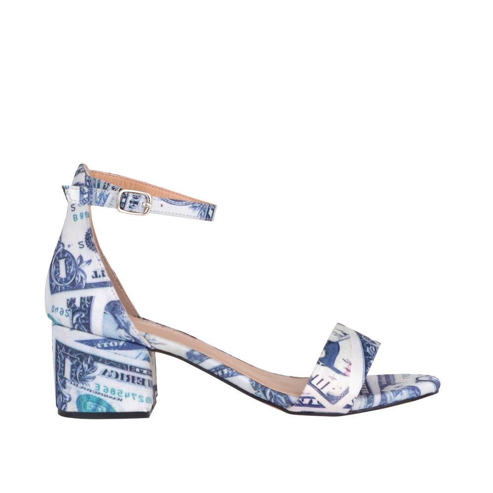 Heel flats with a black and white pattern with strap and ankle buckle closure-side view