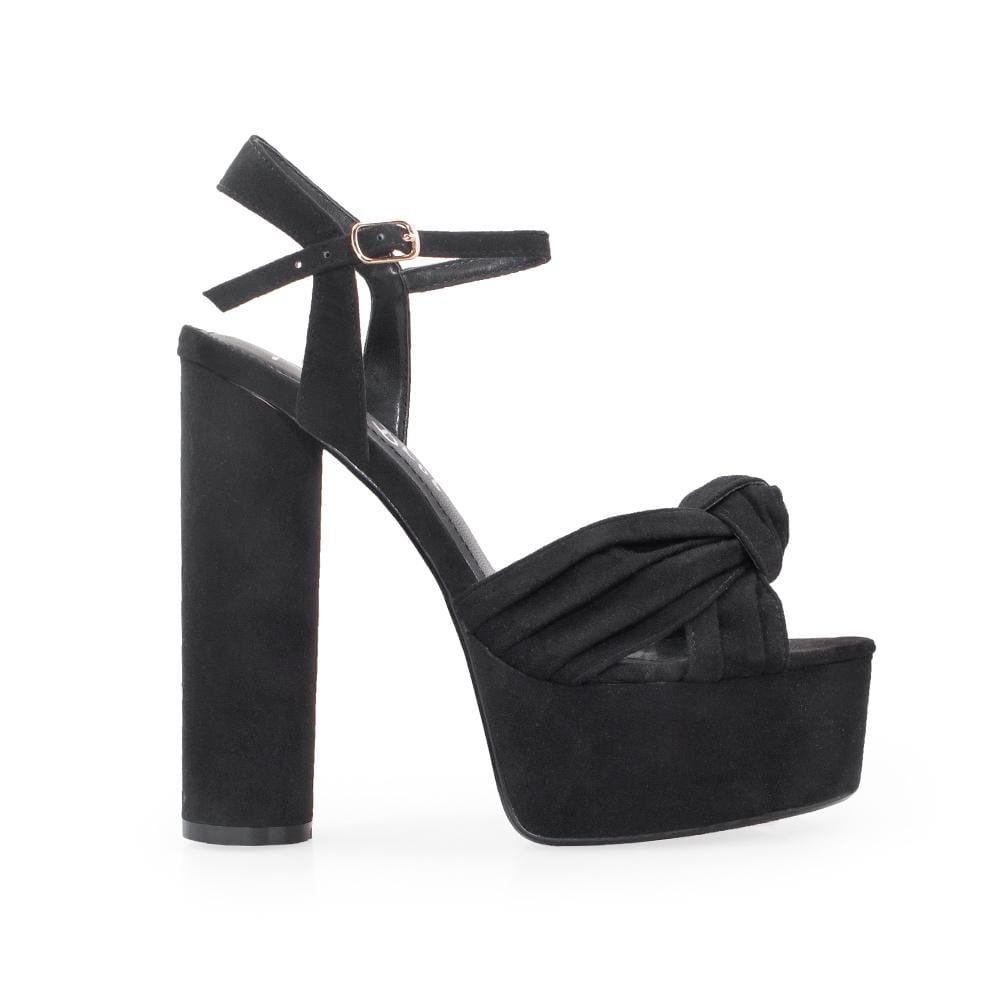 Black platforms with block heels and ankle buckle clasp