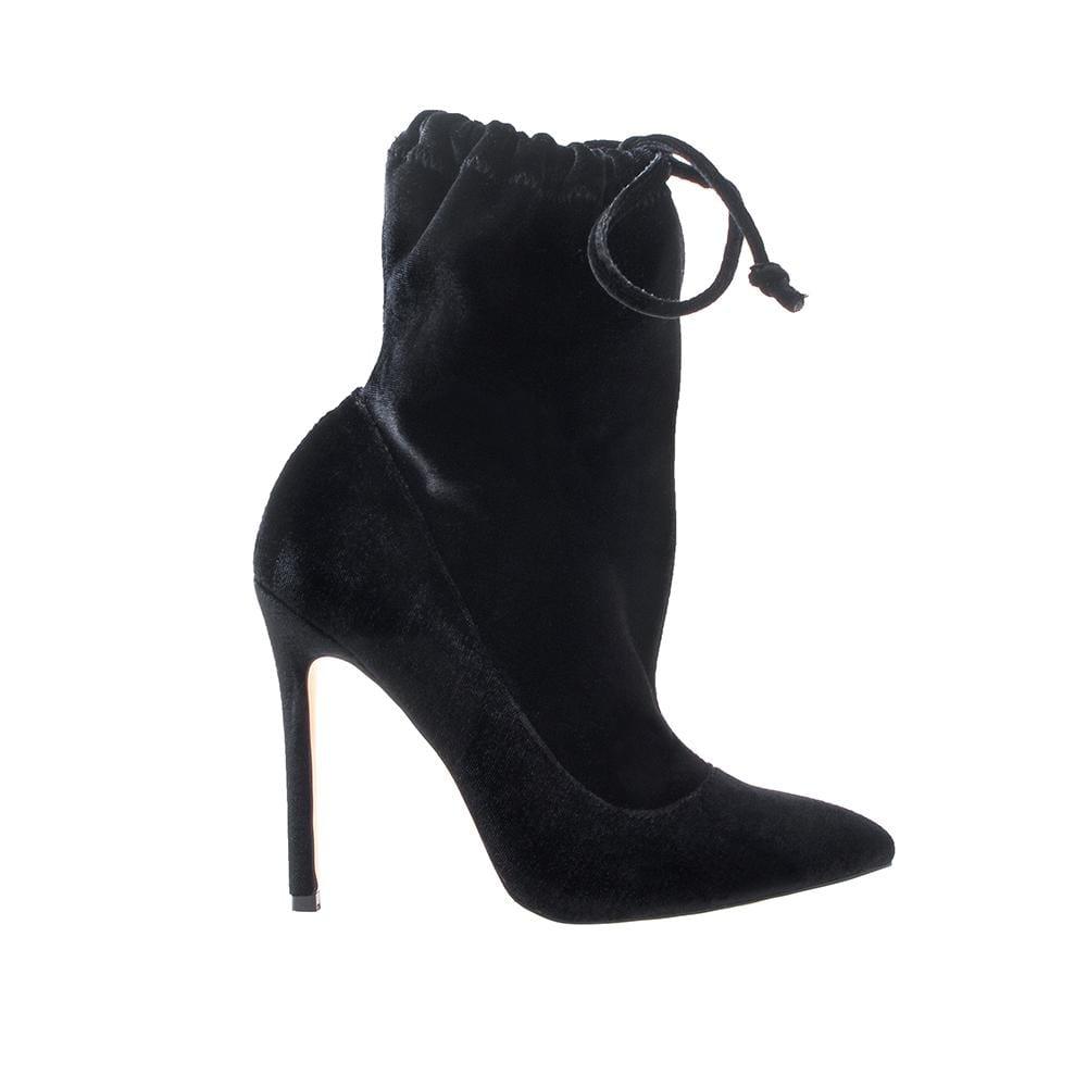 Women's black velvet heels with pull-on style, lace-up clasp, and pointed toe.