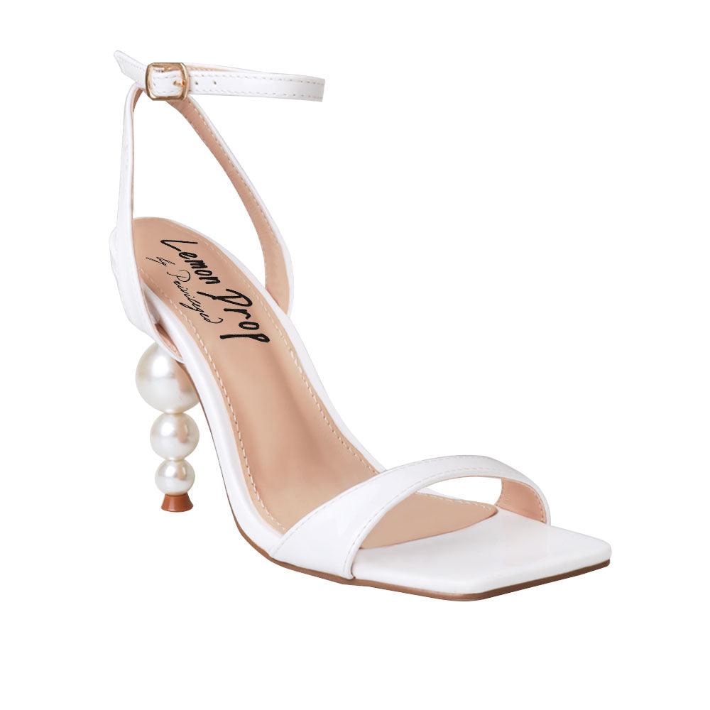 White colored women heels with ankle buckle closure and three tiered pearl heel-corner view