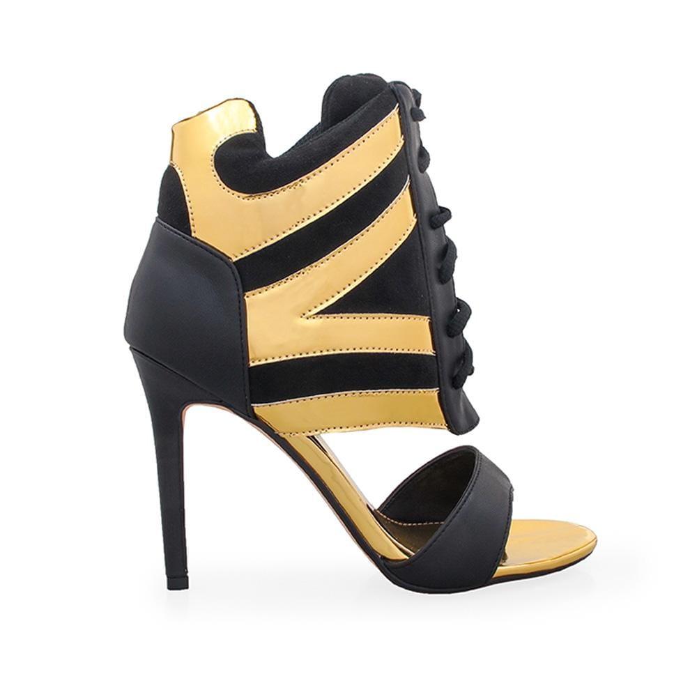 Black and gold colored women heels