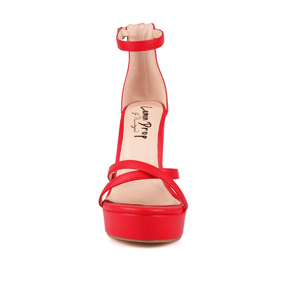Red platform heels with ankle buckle closure and open toe design - front view