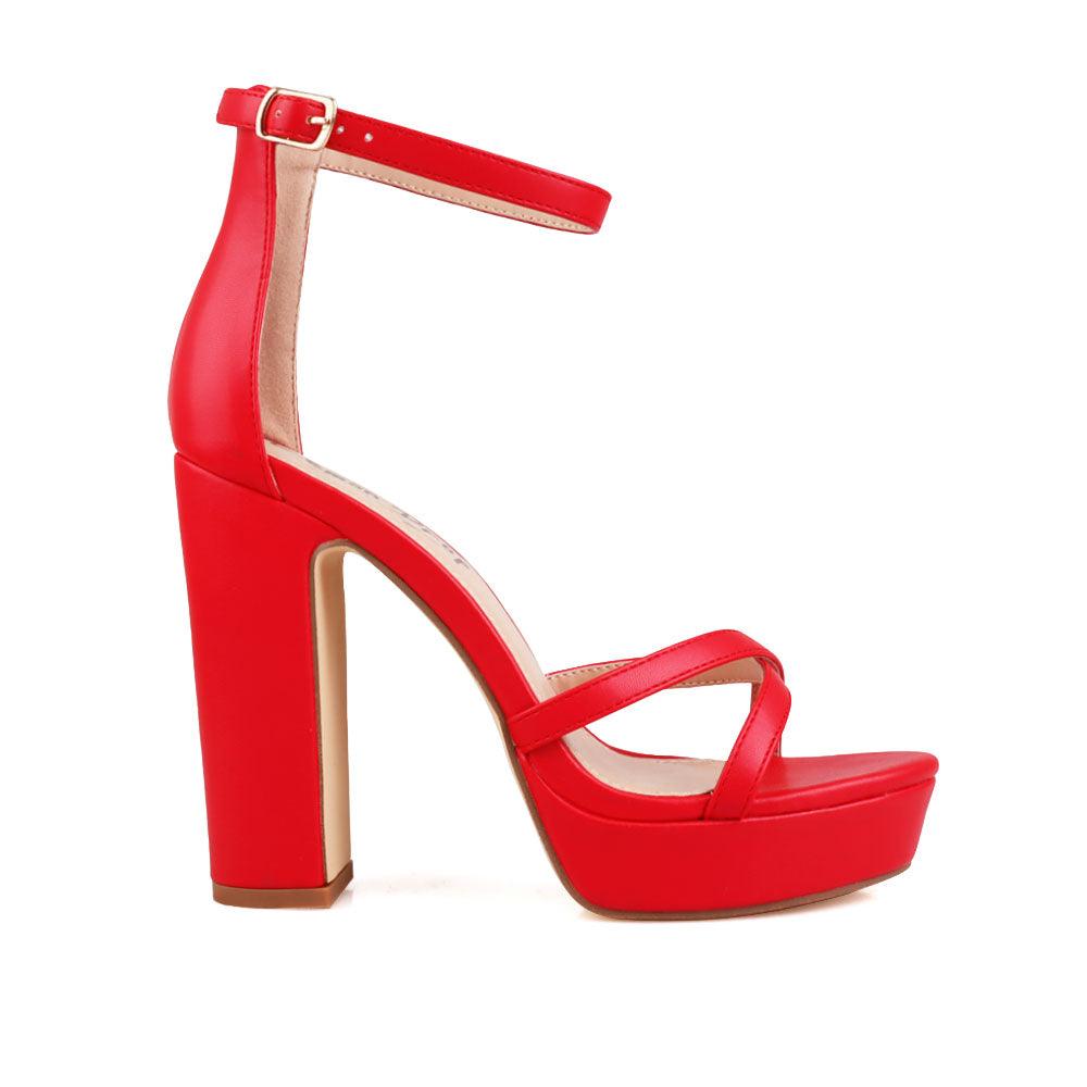 Red platform heels with ankle buckle closure and open toe design - side view