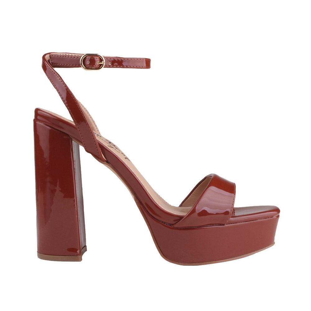 Platforms in cognac with block heels and ankle buckle clasp.