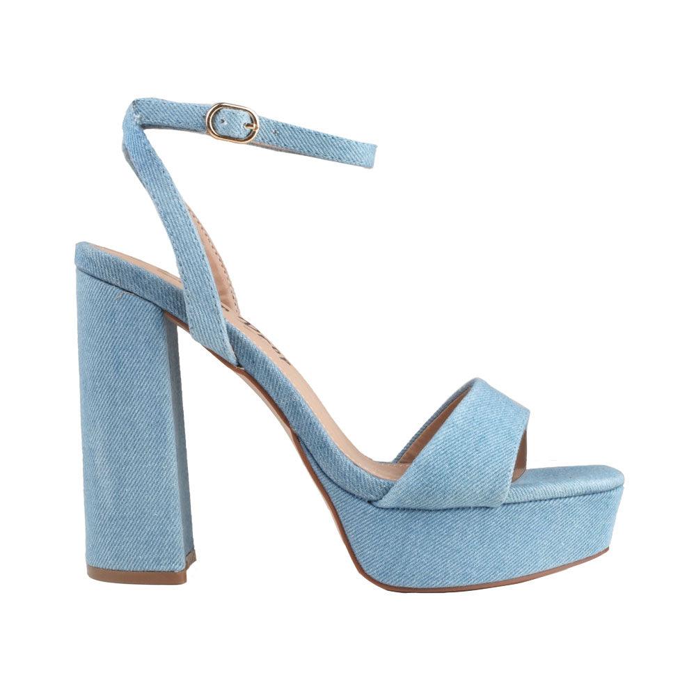 Platforms in denim- color with block heels and an ankle buckle clasp.
