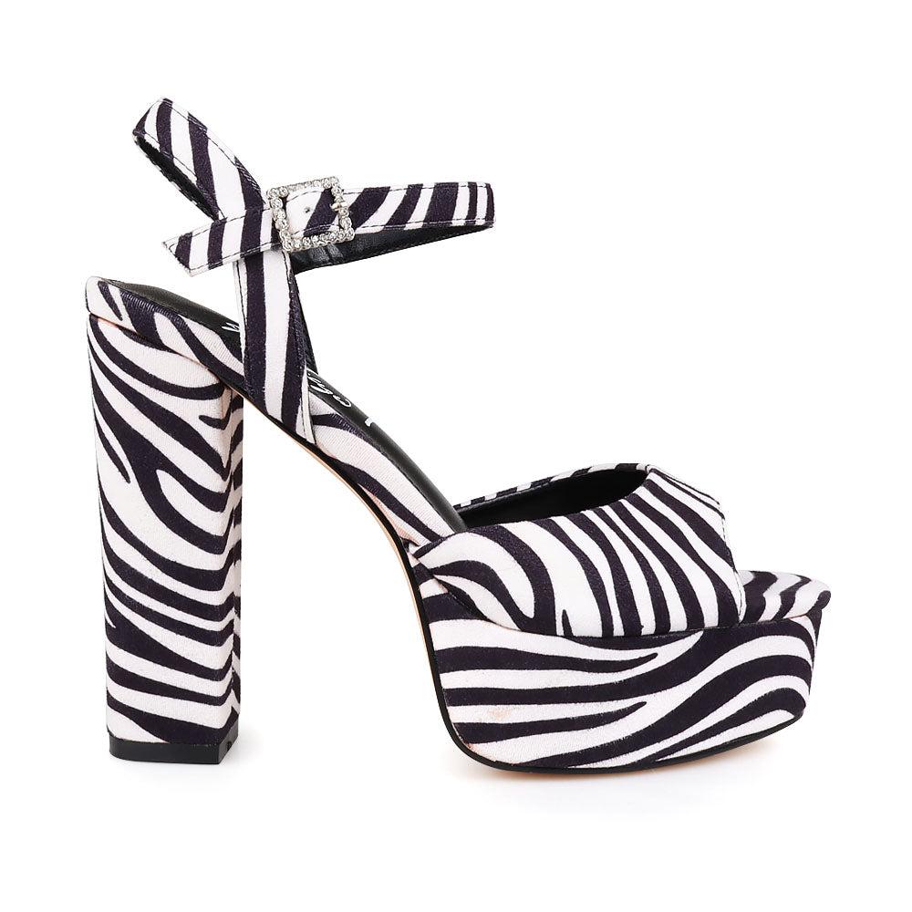 Platform heels for women featuring zebra pattern design and an ankle buckle fastening.