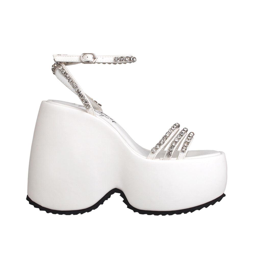 Platforms in white with ankle buckle clasp and multiple straps decorated with gems