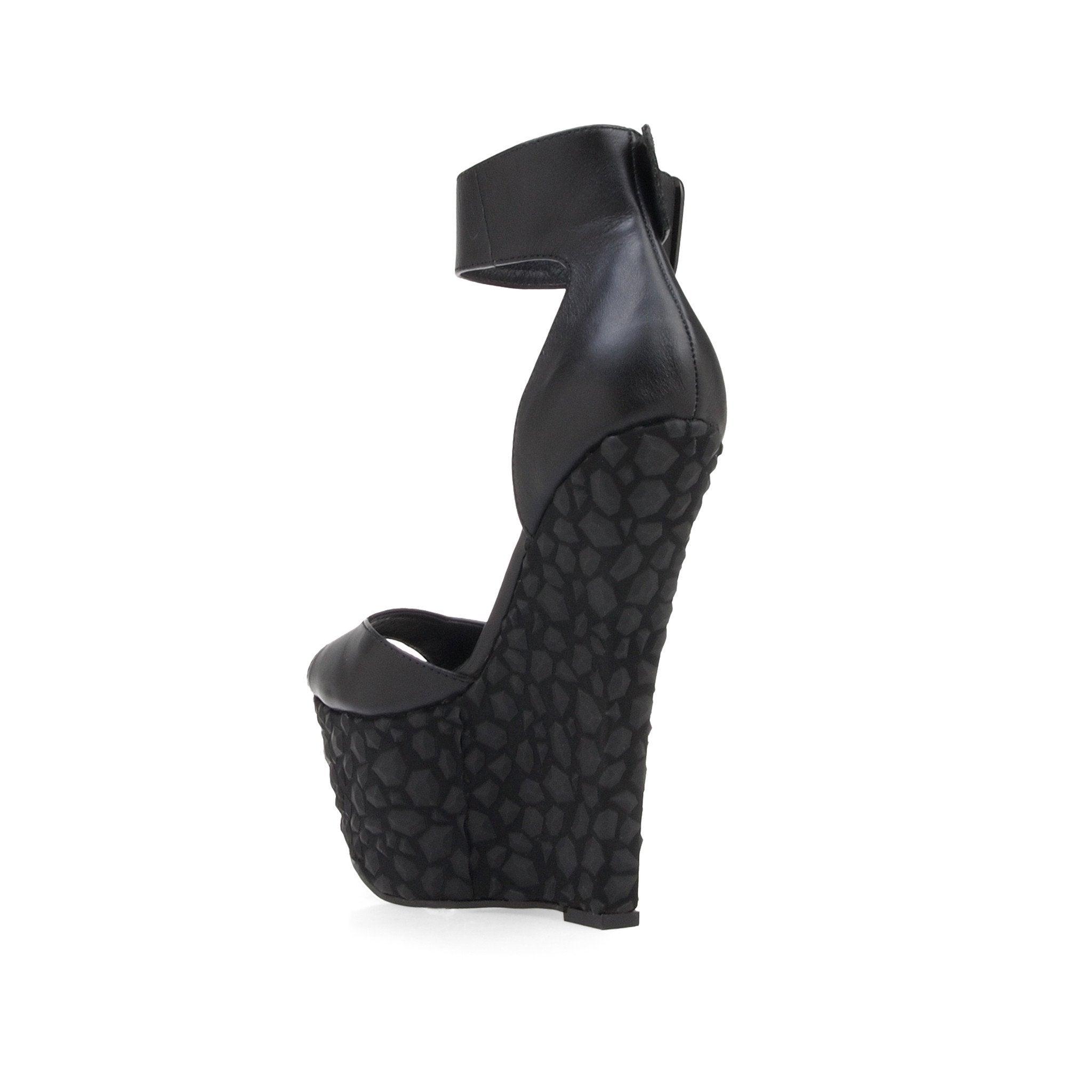 Leather wedge women's heel in black-posterior view
