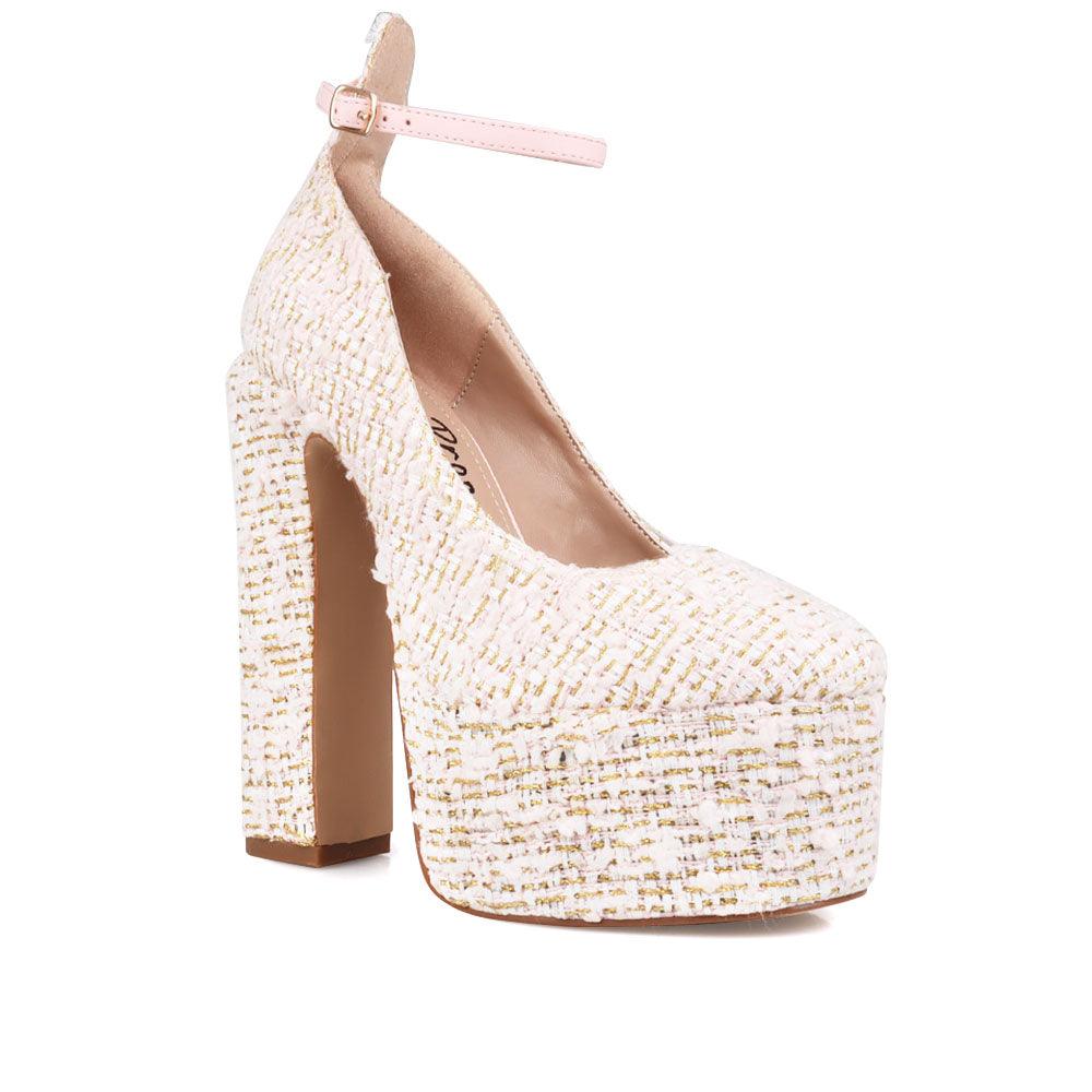 Cream colored women platforms with ankle buckle closure-corner view