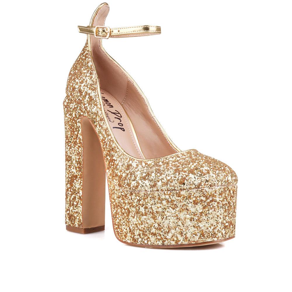 Golden colored women platforms with ankle buckle closure-corner view