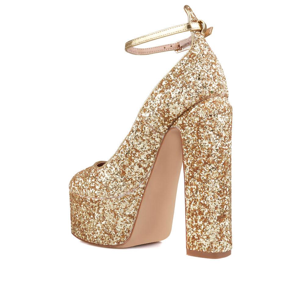 Golden colored women platforms with ankle buckle closure-posterior view