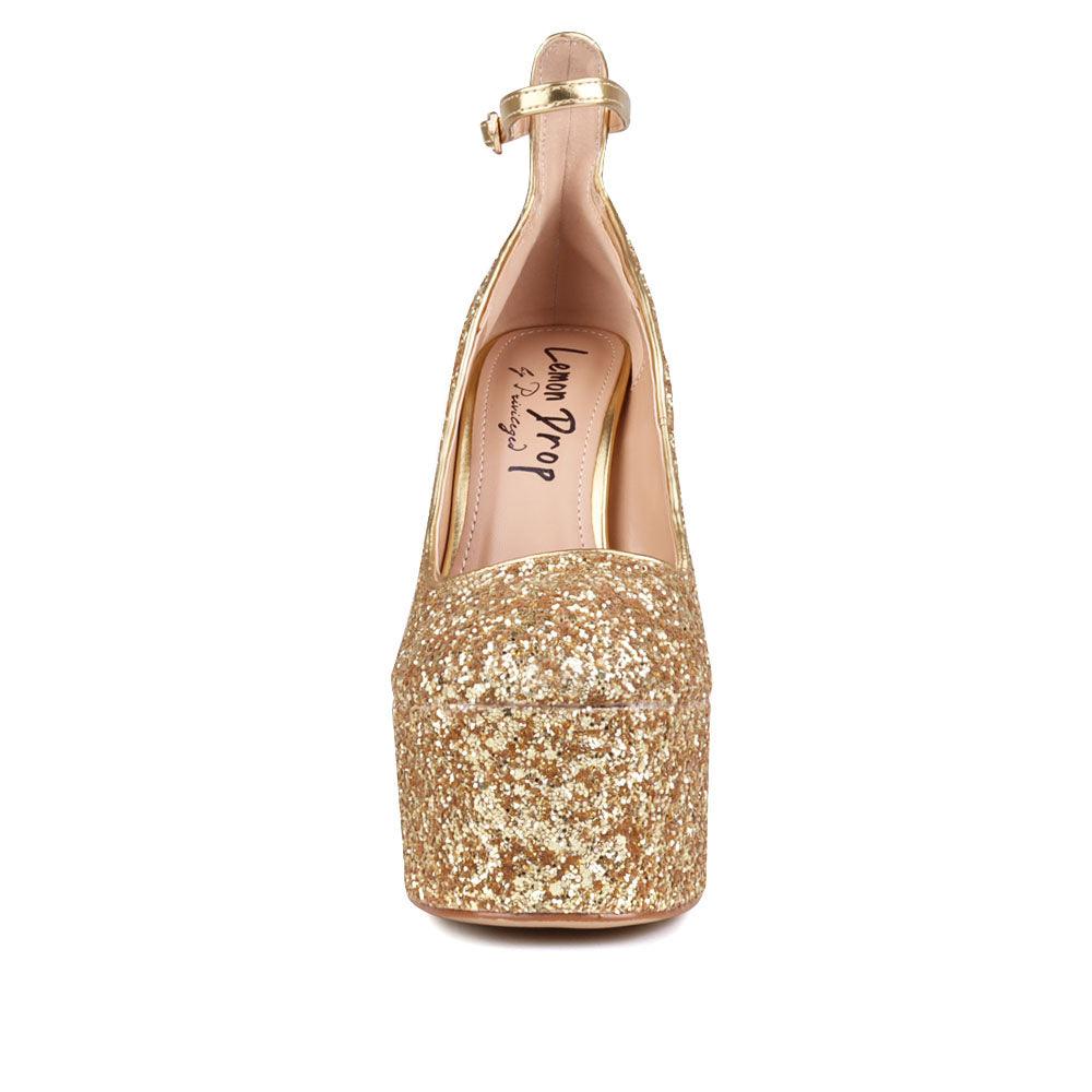 Golden colored women platforms with ankle buckle closure-front view