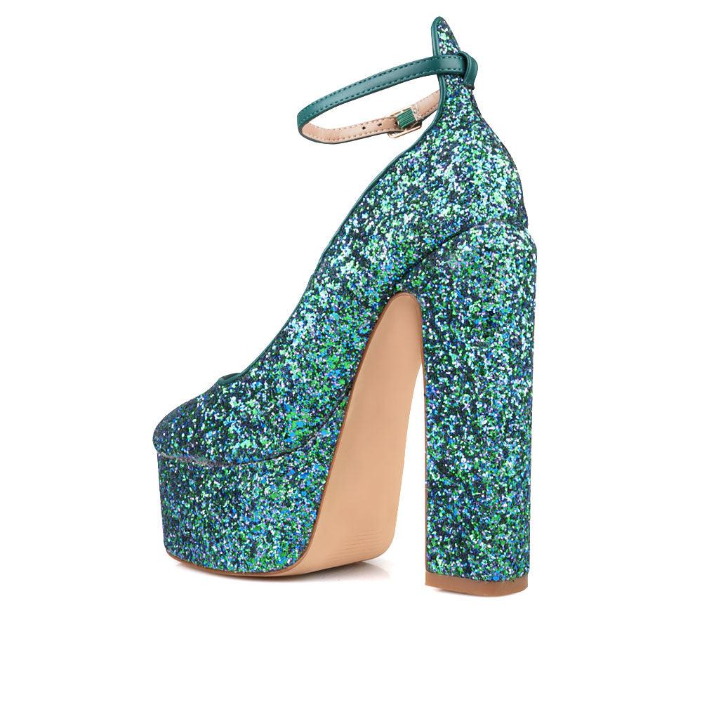 Green colored women platforms with ankle buckle closure-posterior view