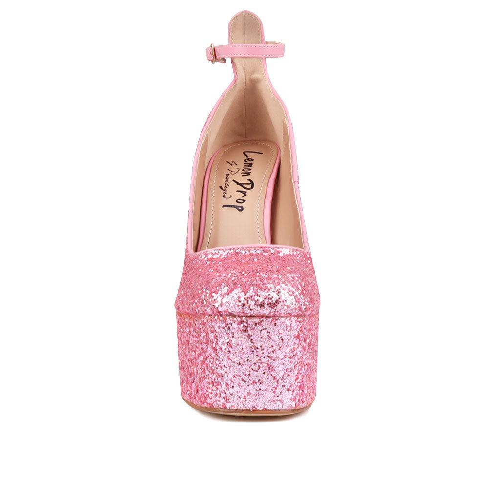 Pink colored women platforms with ankle buckle closure-front view