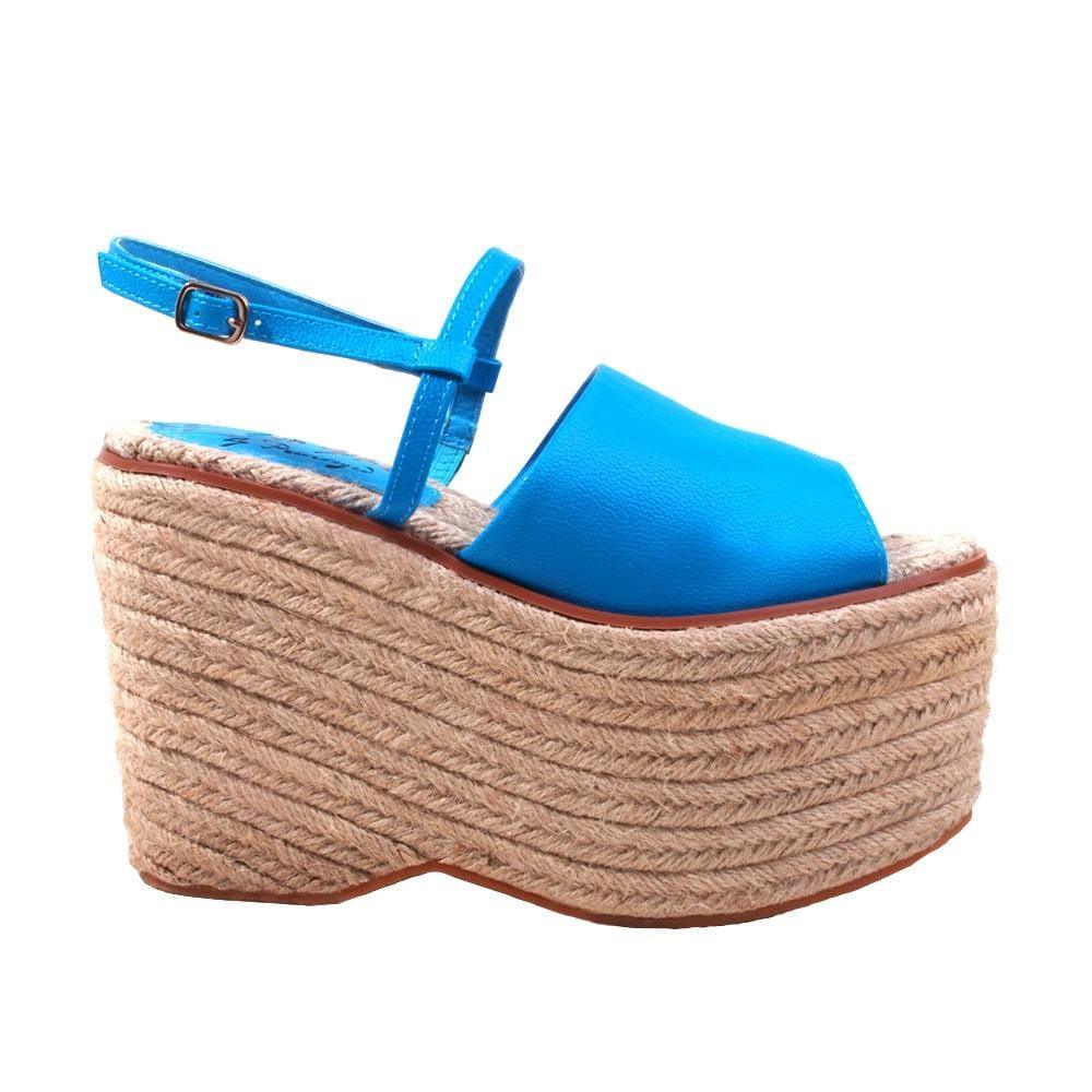 Tan wedge with blue top and an ankle buckle closure