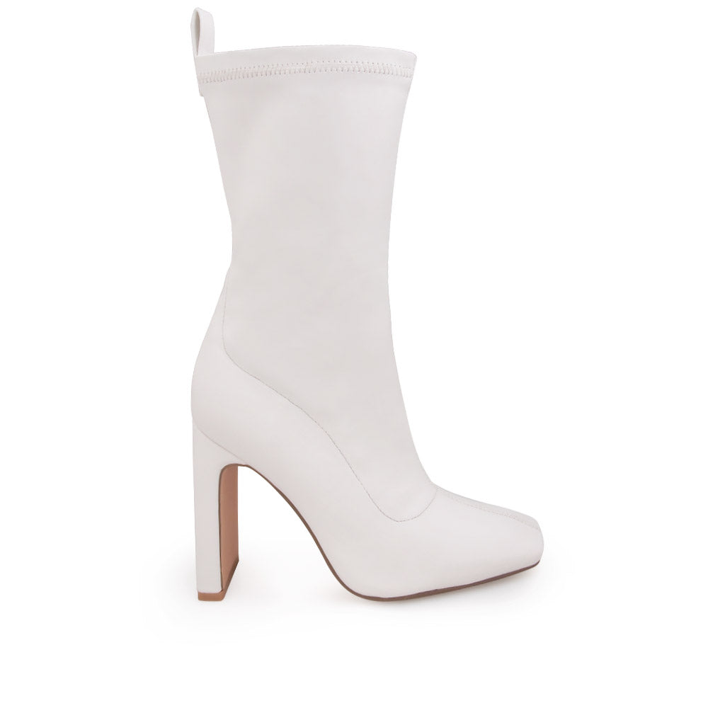 White ankle-high heels with a pointed toe and zip closure - side view