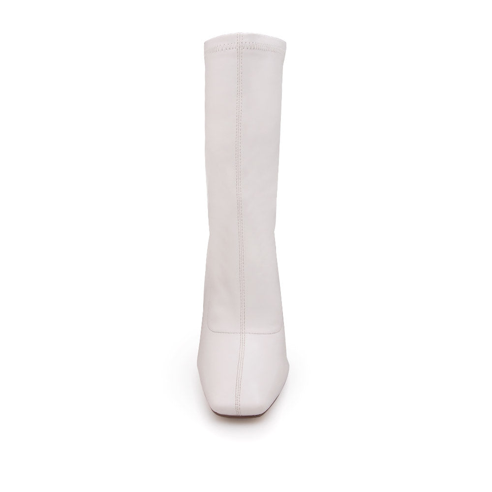 White ankle-high heels with a pointed toe and zip closure - front view