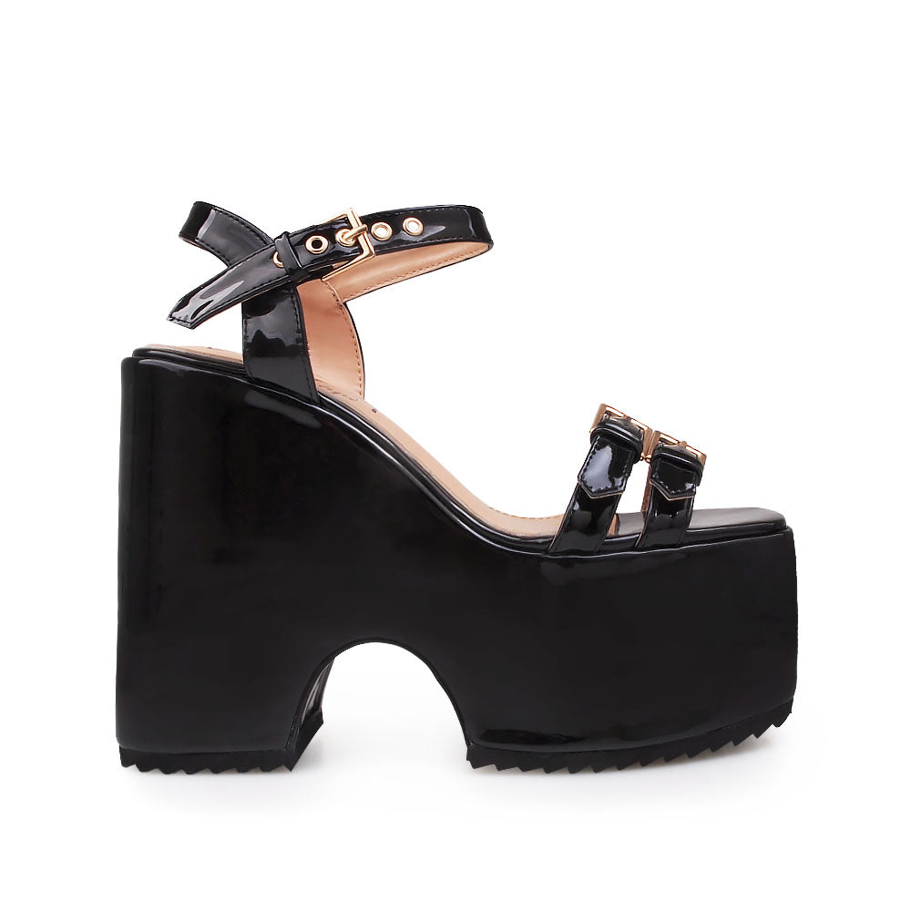 Black colored platforms sandals with double buckle strap design and ankle buckle closure - side view