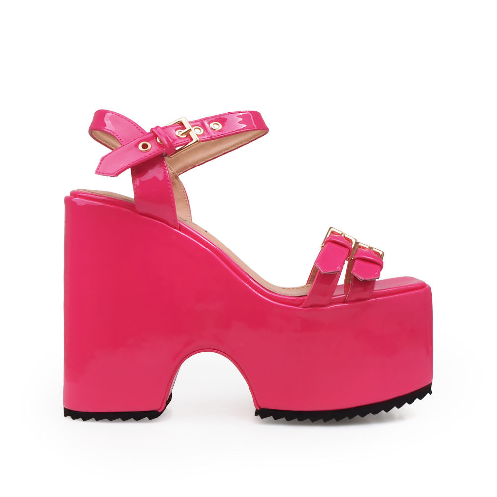 Fuchsia colored platforms sandals with double buckle strap design and ankle buckle closure - side view