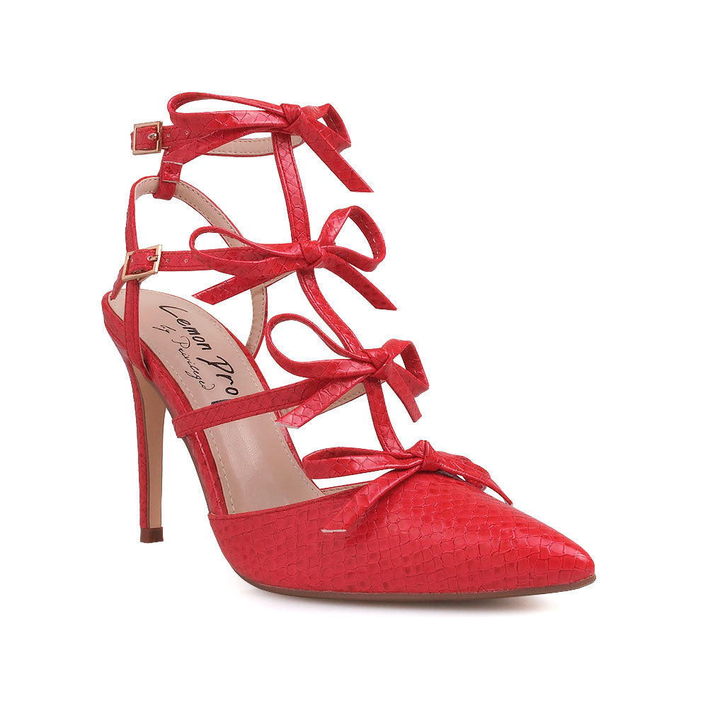 Red colored stiletto sandals with bow design and double ankle strap - corner view