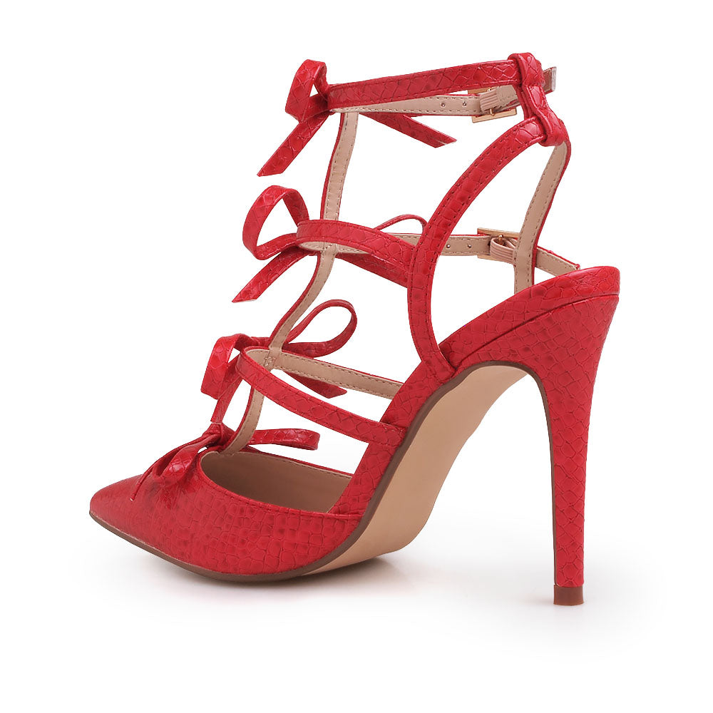 Red colored stiletto sandals with bow design and double ankle strap - back view