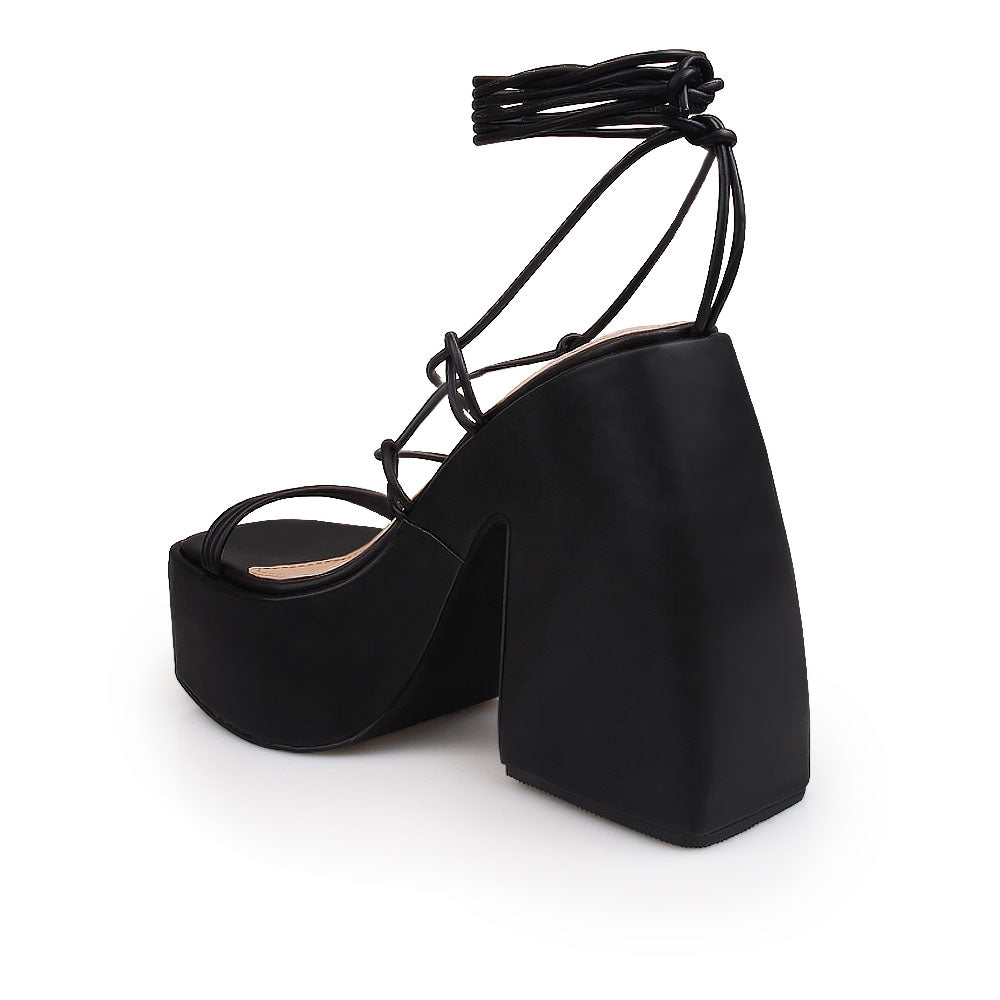 Black colored strappy platform heeled sandals - back view