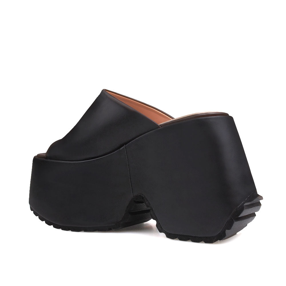 Black platforms with an open toe and slip-on style - back view