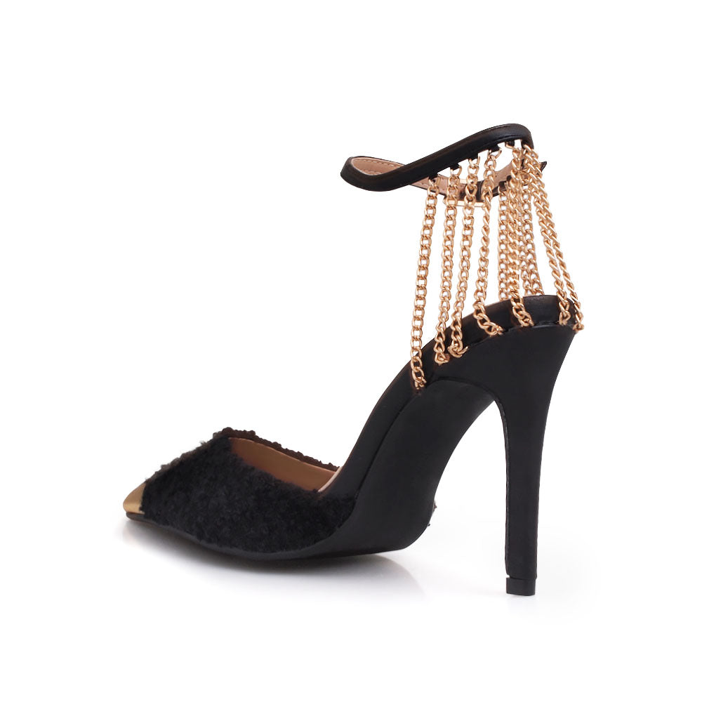 Black stiletto heels with gold chain accents and ankle buckle closure - back view